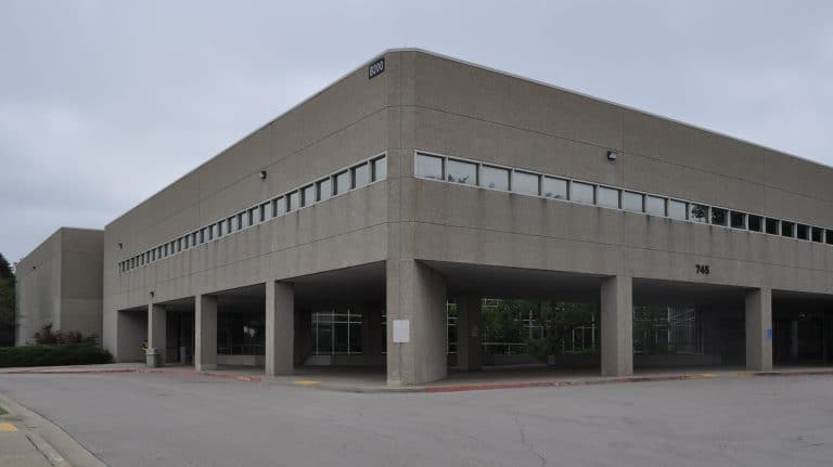 Front view of commercial property at 745 New Circle Rd, Lexington, KY, featuring brick façade and ample parking