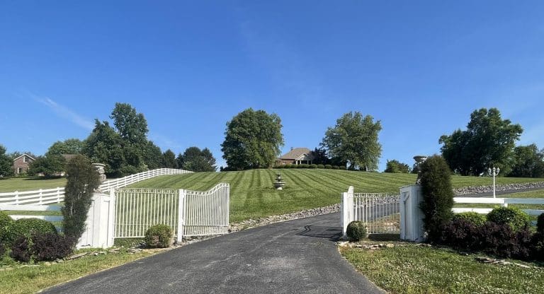 Front of home and driveway with land